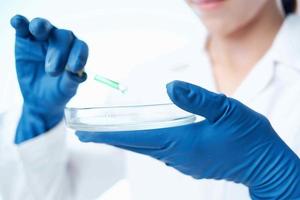 woman with blue gloves laboratory research science photo