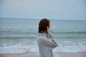 beautiful woman red hair in a sweater by the ocean Lifestyle photo