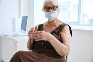 old woman in medical mask vaccination health immunity photo