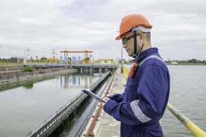 Water plant maintenance technicians, mechanical engineers check the control system at the water treatment plant. photo