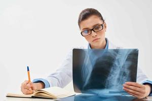 woman doctor sitting at the table radiologist diagnostics professionals photo