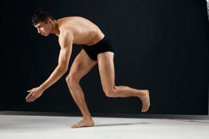 male bodybuilder nude muscular body in black panties posing Studio photo