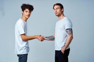 two men friendship shaking hands isolated background photo