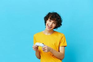 man yellow T-shirt with joystick video games isolated backgrounds photo