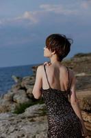 beautiful woman in dress on nature rocks landscape luxury unaltered photo