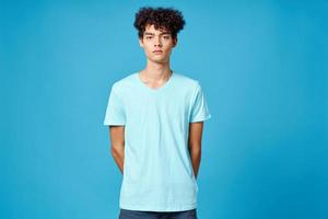 cute guy curly hair blue t-shirt isolated background photo