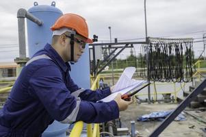 Water plant maintenance technicians, mechanical engineers check the control system at the water treatment plant. photo