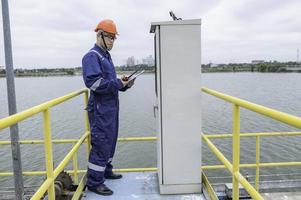 Water plant maintenance technicians, mechanical engineers check the control system at the water treatment plant. photo