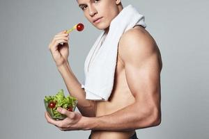 man with white towel and shoulders eating healthy food bodybuilder photo