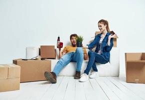 Young couple with boxes of things tools room interior photo