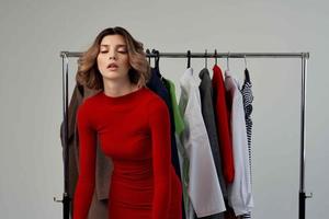 beautiful woman in a red jacket near the wardrobe emotions photo