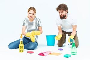 Young couple wash floors at home interior light background lifestyle photo