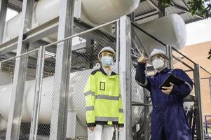 Engineers work place to keep liquid helium,preventive maintenance schedule checking,Thailand people,Technicians and engineers discuss work together. photo