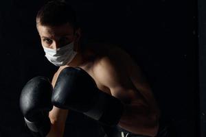 guy in medical mask and in boxing gloves on isolated background cropped view Copy Space photo