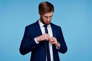 man in a suit straightens his tie self confidence fashion businessman photo