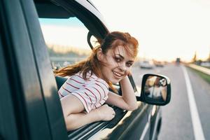 Cheerful woman in car trip journey road photo