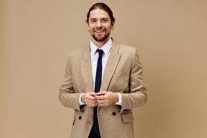 man in beige jacket in a suit with a tie posing isolated background photo