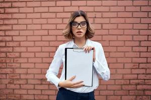 Business woman manager glasses paperwork brick wall on background photo