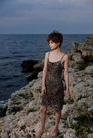 woman in dress in dress on nature rocks landscape luxury photo