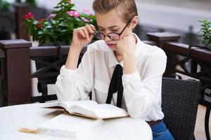 student with a book in his hands outdoors reading education photo