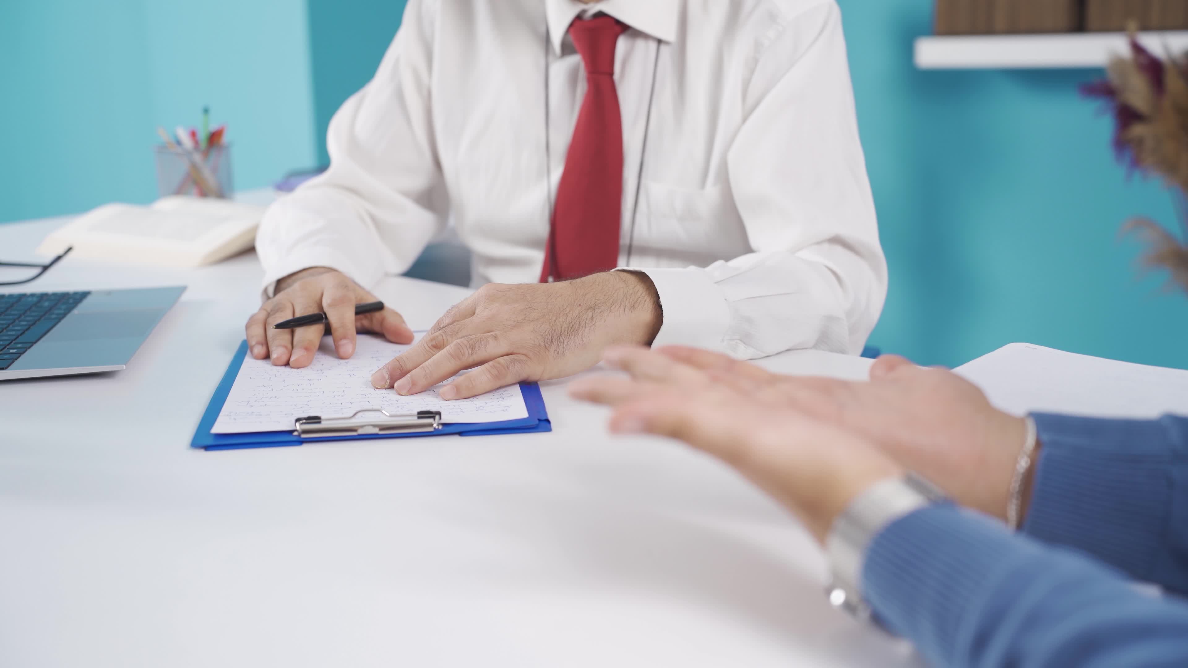 Male Psychiatrist listening to adult stressed male patient and writing
