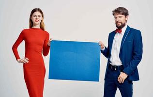elegant man and woman holding mockup poster in hand advertising photo