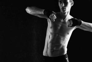 man with a pumped-up torso workout exercise sport dark background photo