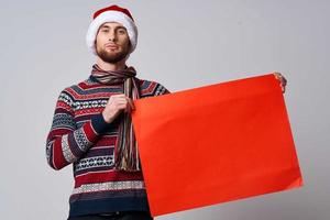 Cheerful man in New Year's clothes holding a banner holiday isolated background photo