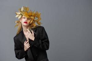 portrait of a woman golden leaves on the head in black jacket Lifestyle posing photo