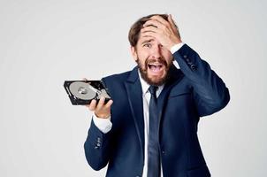 emotional business man with hard drive on computer technology photo