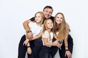 cheerful friendly family hug studio isolated background photo