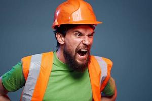 Emotional builders orange hard hat safety work fatigue blue background photo