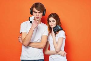 young couple in white t-shirts with joysticks in hands playing entertainment photo