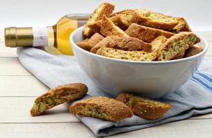 Cantucci d'Abruzzo with pistachios and citron on wooden table.