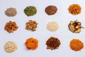 Healthy vegetarian food concept. Assortment of dried fruits, nuts and seeds on white background. Top view. photo