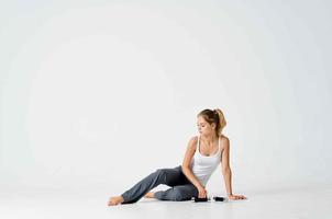 woman sitting on the floor doing sports exercise photo