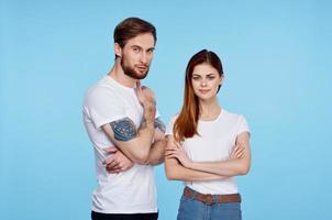 young couple in white t-shirts images of communication with him studio photo