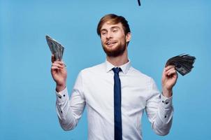 Cheerful man with wads of money in his hands success rich man photo