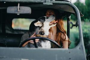 Woman and husky dog happily traveling in car smile with teeth fall walk with pet, travel with dog friend hugs and dances photo