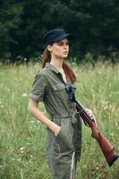 Woman on outdoor A woman with a gun holds her hand in a pocket of a black cap photo