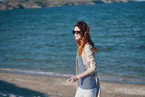 woman in sunglasses in summer outdoors on the beach sea travel photo