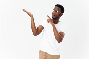 African man shows his hand to the side on a light background Copy Space model cropped view photo