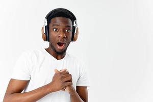 man african appearance with open mouth headphones listening to music emotions isolated background photo