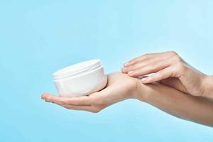 woman holding a jar of cream close-up dermatology skin care photo