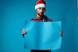 emotional man in a santa hat holding a banner holiday studio posing photo