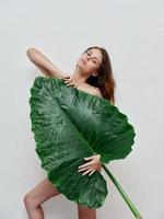 woman with naked body palm leaf Exotic attractive look photo