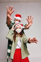 Man and woman in medical masks isolated holiday fun photo