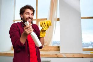 Cheerful cleaner detergent rubber gloves interior window in the background photo