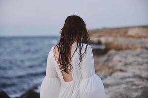 Woman outdoors landscape ocean stones travel unaltered photo