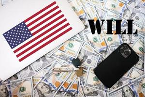 Will concept. USA flag, dollar money with keys, laptop and phone background. photo